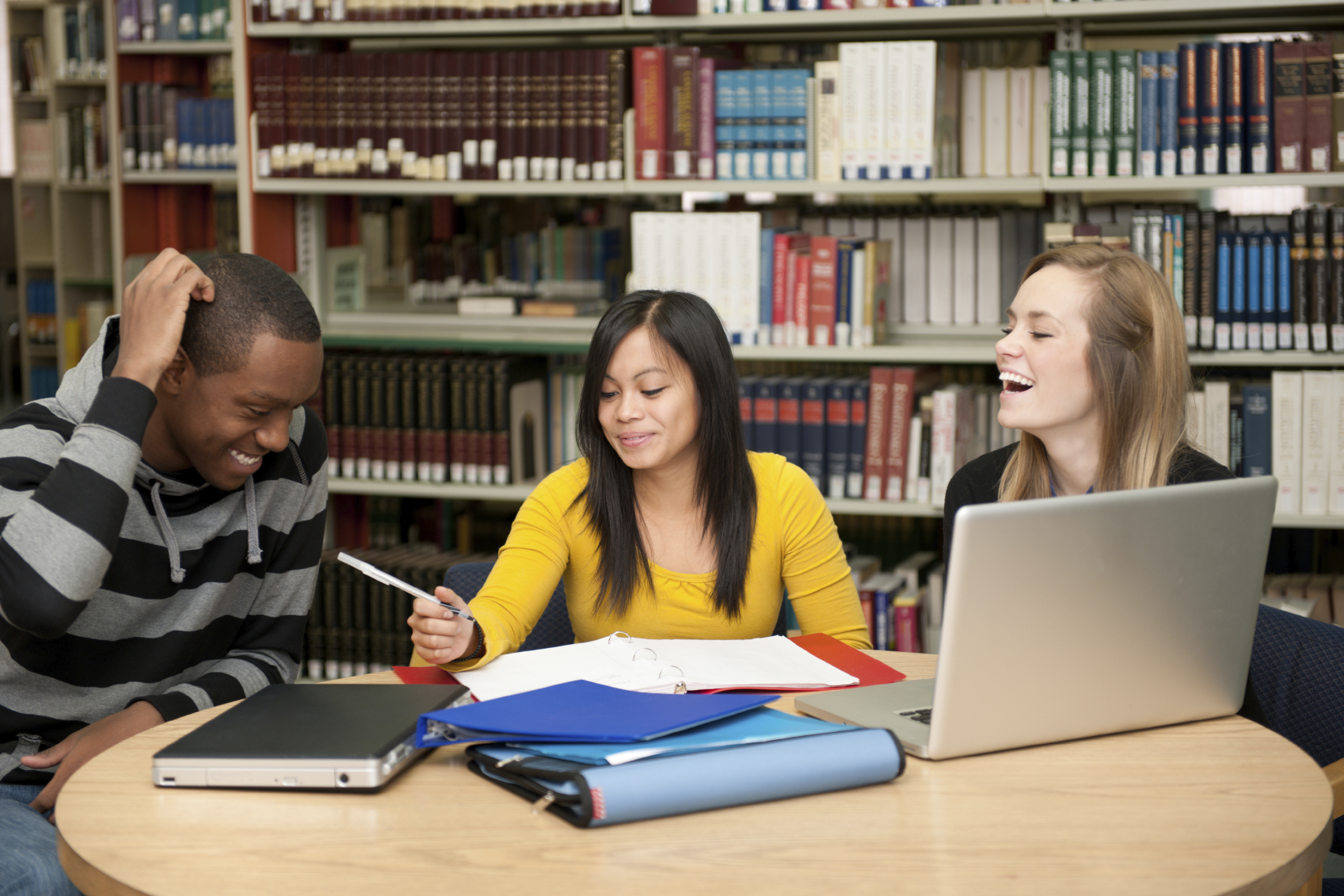 College students studying in a library of books 