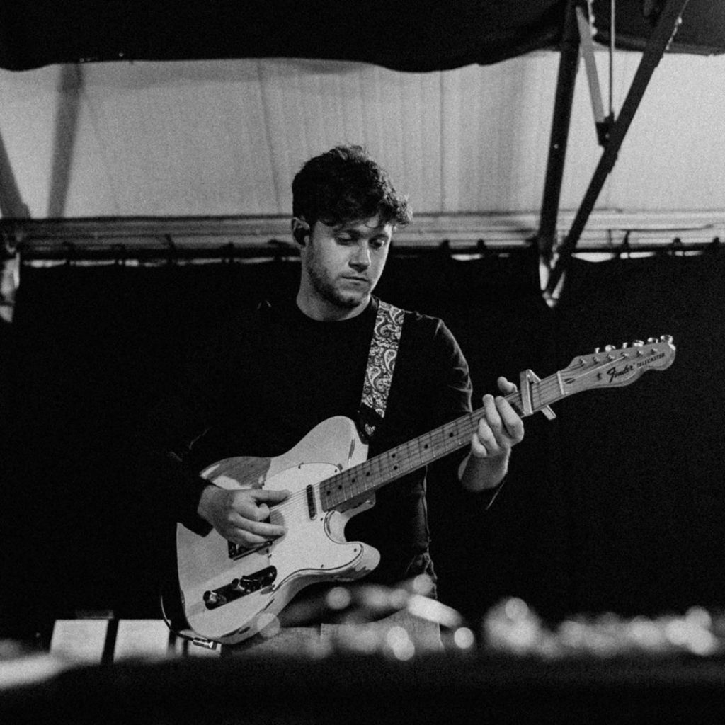 Niall Horan playing guitar