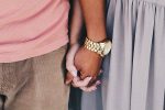 unplash image of couple holding hands for megan thompson's article about cuffing season