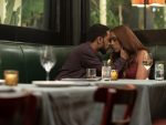 Characters from "The Photograph" in a restaurant.