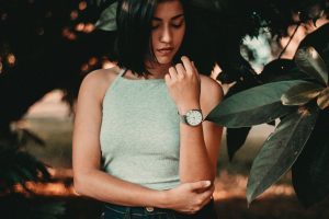 A woman stares at her watch; the biological clock is always ticking, and for some people, egg freezing is a great way to fight back