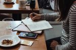 picture of student doing homework in an article about earning money while in school