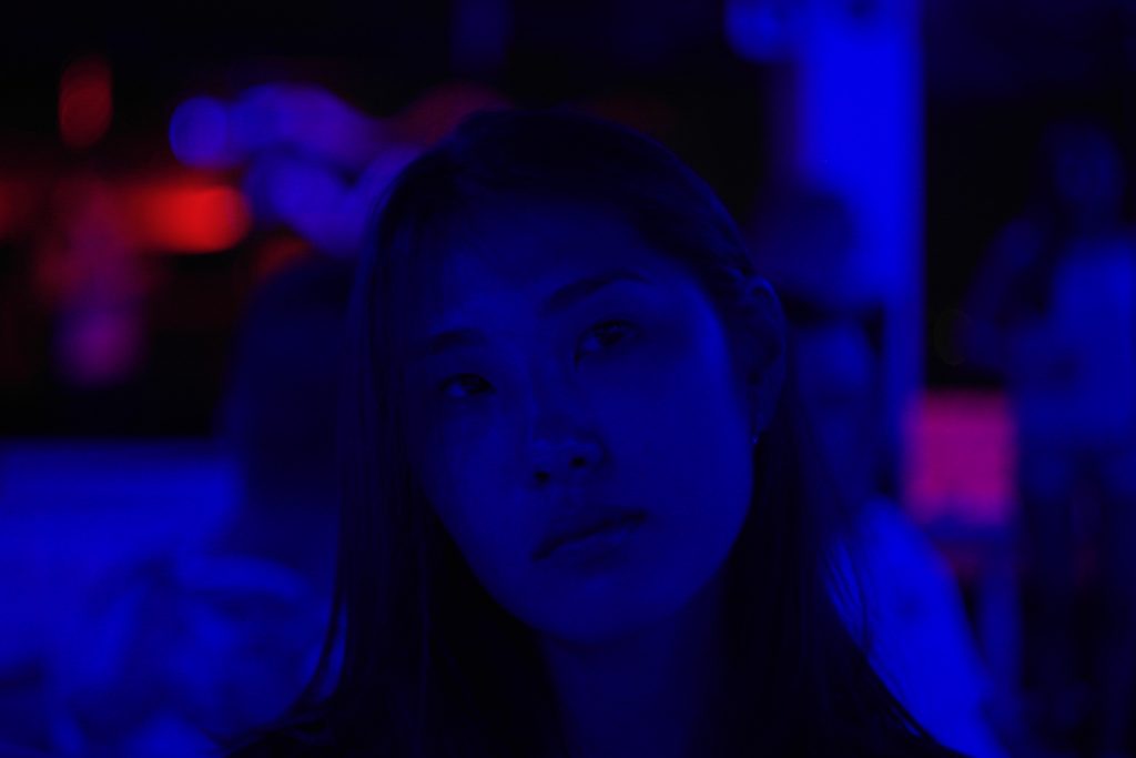 Describing stigma surrounding Asian-American women, many of these women can be left in the dark when it comes to body positivity in a tug-of-war between their two cultures much like the woman pictured above in a dark scene with little light.