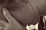 Picture of woman crying in an article about being quarantined in abusive households