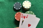In an article about card counting, a person holding a a King and an Ace over some casino chips