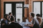 In an article about what to do after college, a picture of four people on laptops working around a desk