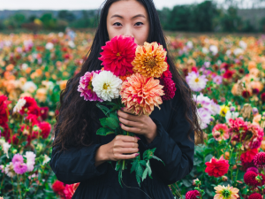 Asian American woman holding flowers