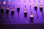 knobs on studio equipment in an article about the music industry