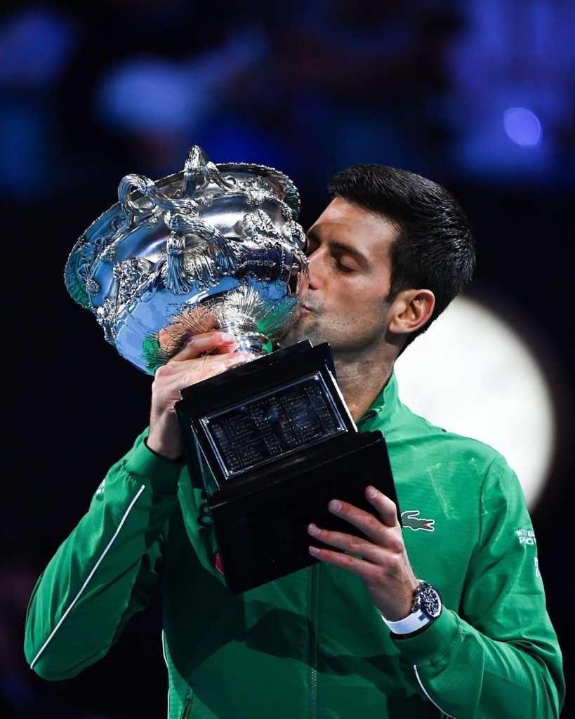 Novak Djokovic kissing a trophy