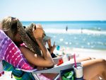 in an article about tan lines, a woman tans in the summer sun rays