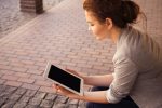 Image of a woman looking at an iPad in an article about intermediate level language learners