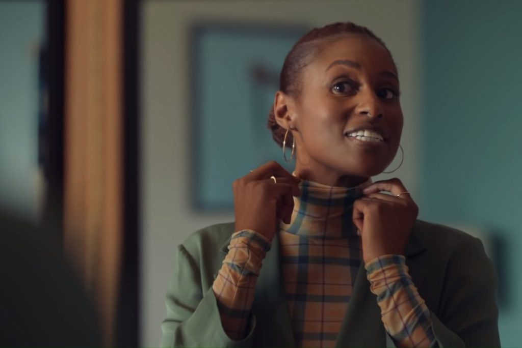 Issa Rae, one of many black writers, adjusts her outfit in 'Insecure.'