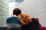 In article about mental health, a person with their head on another person's shoulder