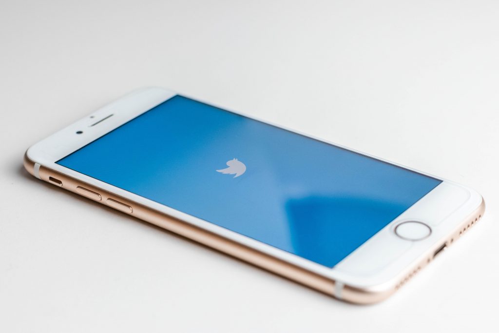 in an article about global protests, smart phone with Twitter logo on the screen; social media