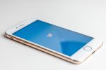 in an article about global protests, smart phone with Twitter logo on the screen; social media
