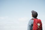 Student looking up into the sky, perhaps considering nonlinear learning.