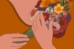 A woman holding a bouquet of dried flowers to herself.