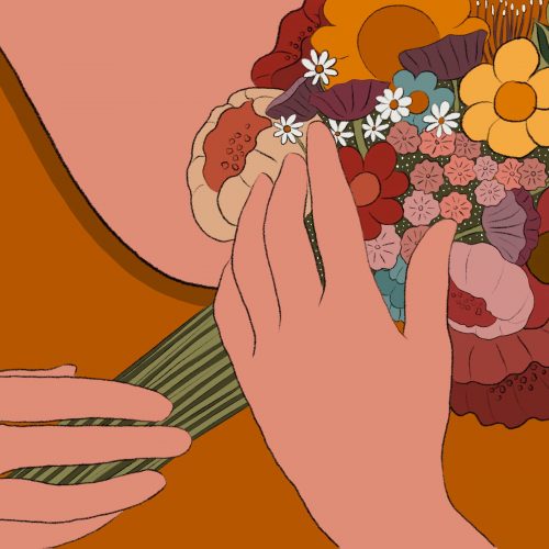 A woman holding a bouquet of dried flowers to herself.
