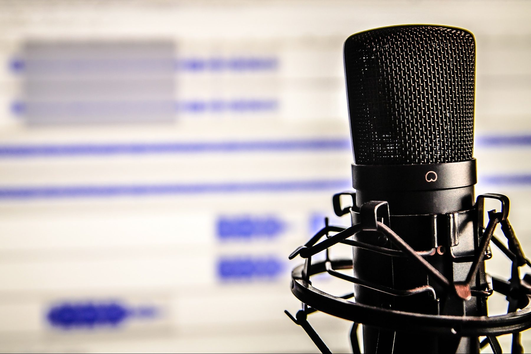 In an article about starting an actual play podcast, a microphone in front of a computer