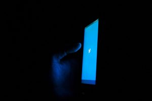Photo of someone using Twitter in the dark