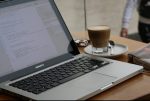 In an article about improving English grades, a computer with a cup of coffee next to it