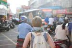 A photo of a woman traveling alone for an article with tips on how to stay safe and save money. (Photo by Steven Lewis from Unsplash)