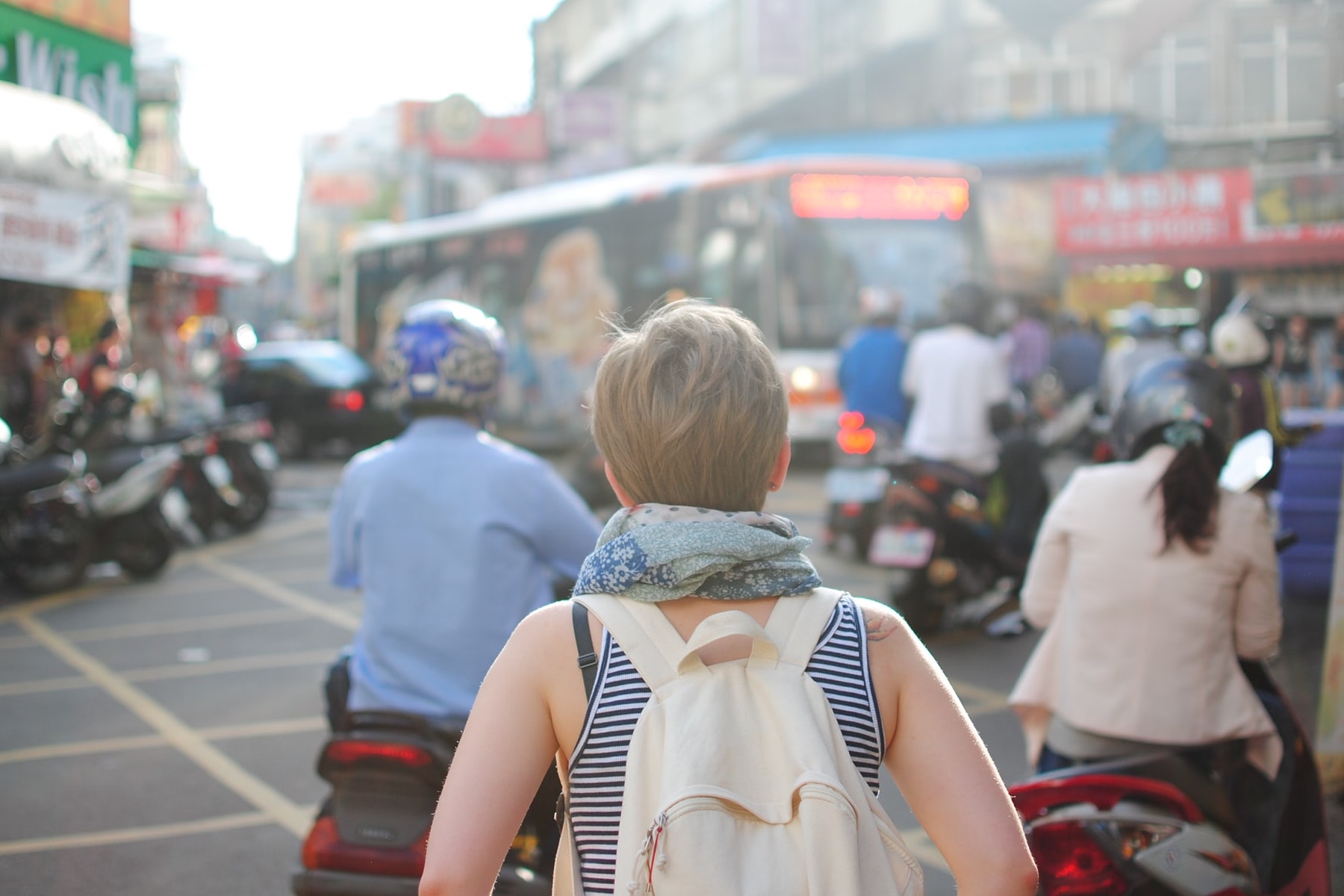 A photo of a woman traveling alone for an article with tips on how to stay safe and save money. (Photo by Steven Lewis from Unsplash)