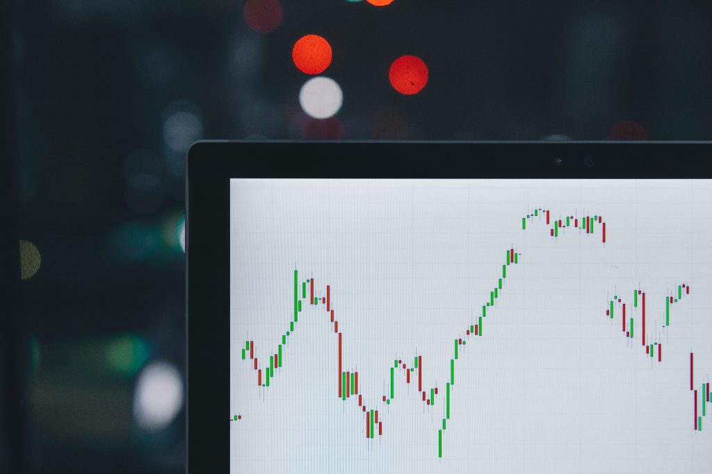 in an article about economics courses, a computer with a stocks line graph