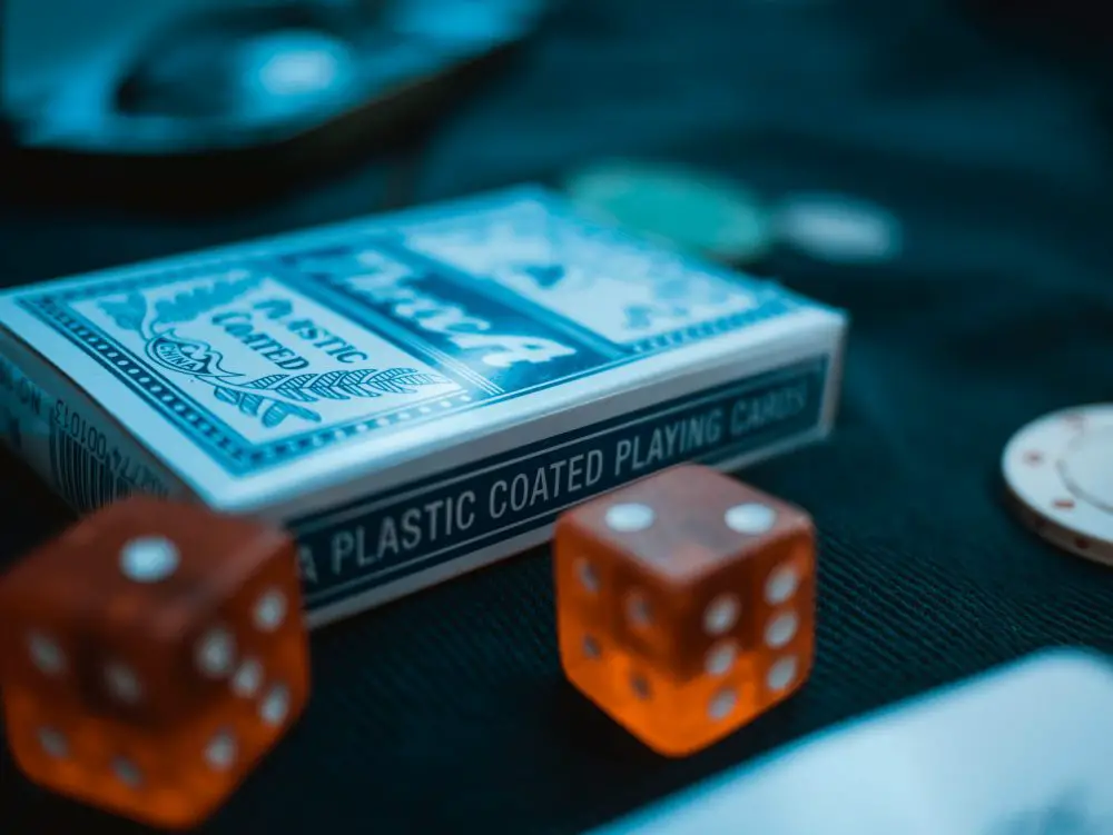 in an article about online casinos, a deck of cards next to some dice