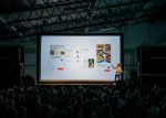 In an article about PowerPoint presentations, someone standing in front of a presentation screen