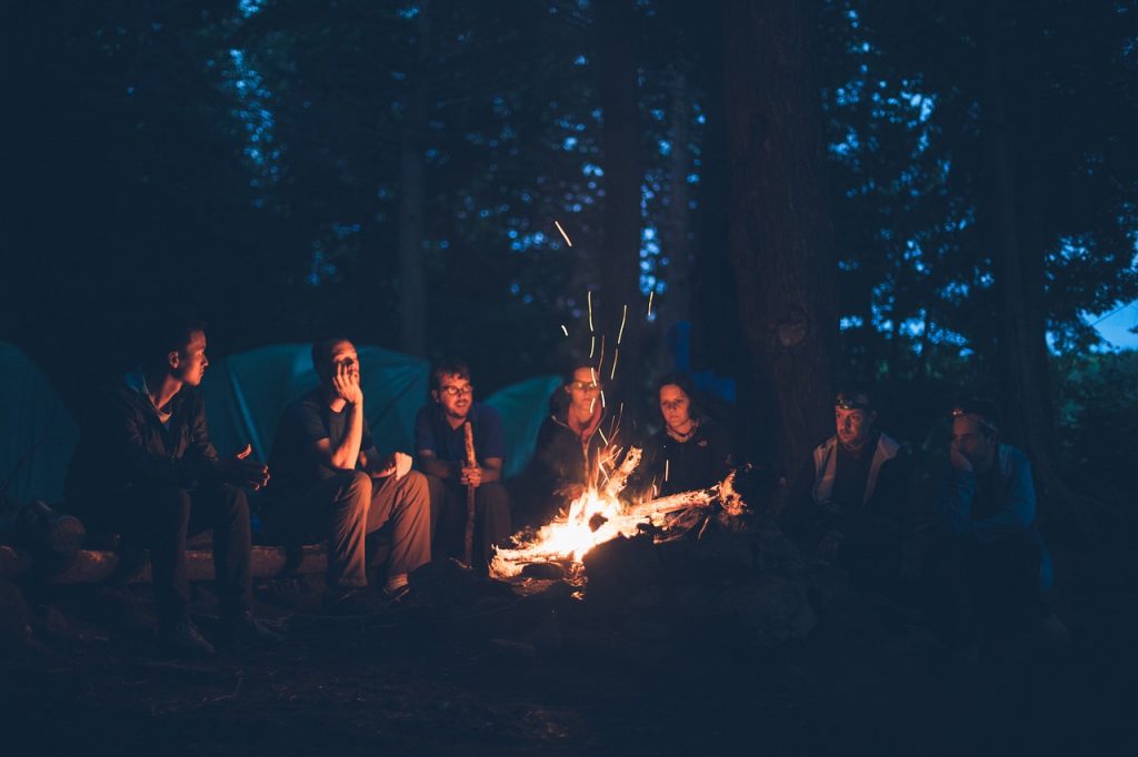 A group of friends around a campfire — the perfect place to read Tolkien