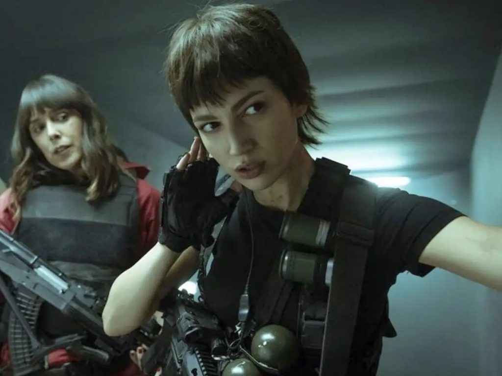 Two women from Netflix show Money Heist are standing in a hallway.