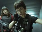Two women from Netflix show Money Heist are standing in a hallway.