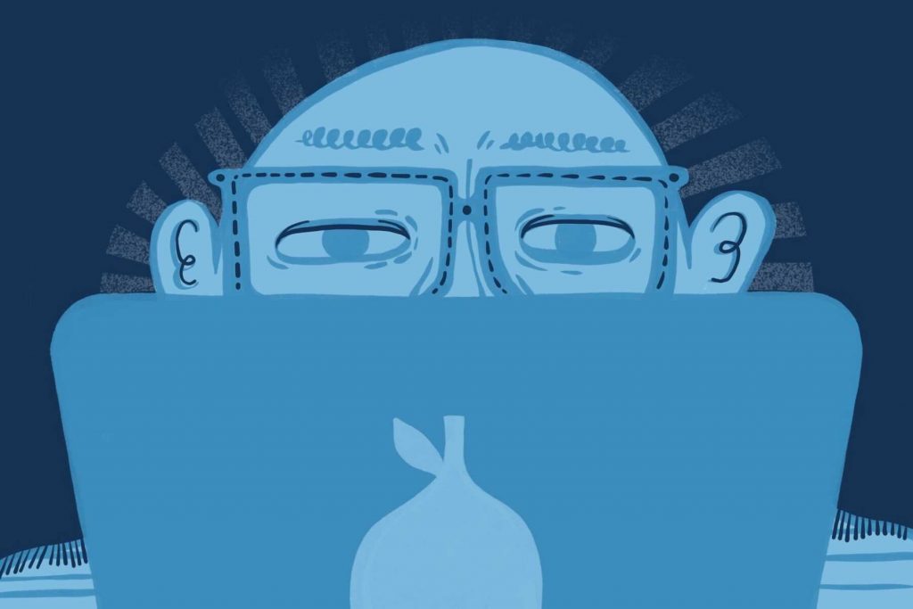 Illustration of person wearing blue light glasses while sitting in front of a laptop
