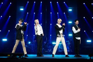 SHINee performing (four members).