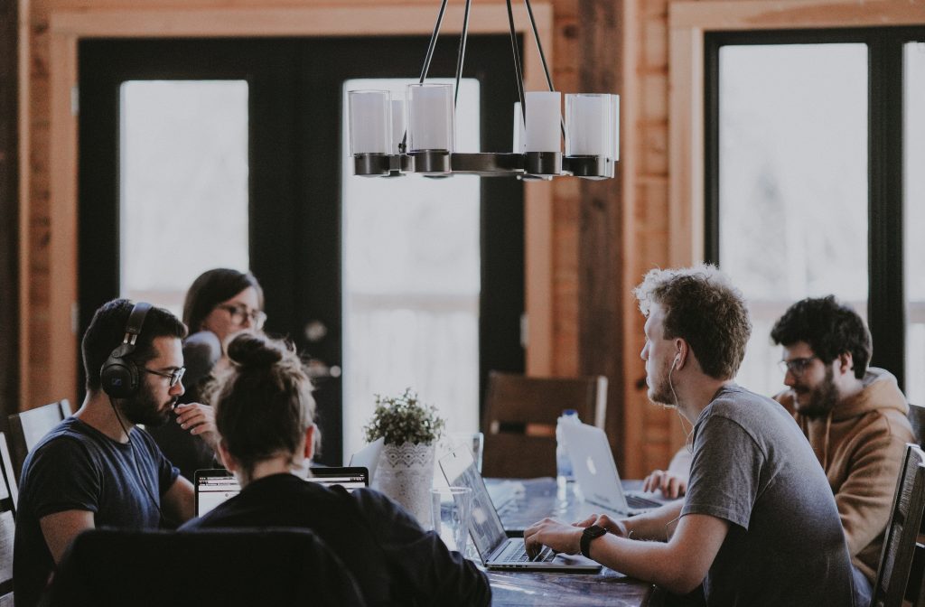 in article about growth hacking, people around a table in a meeting