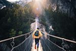 A man running on a bridge for an article about outdoor activities.