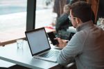 in article about essay writing, a person at their laptop