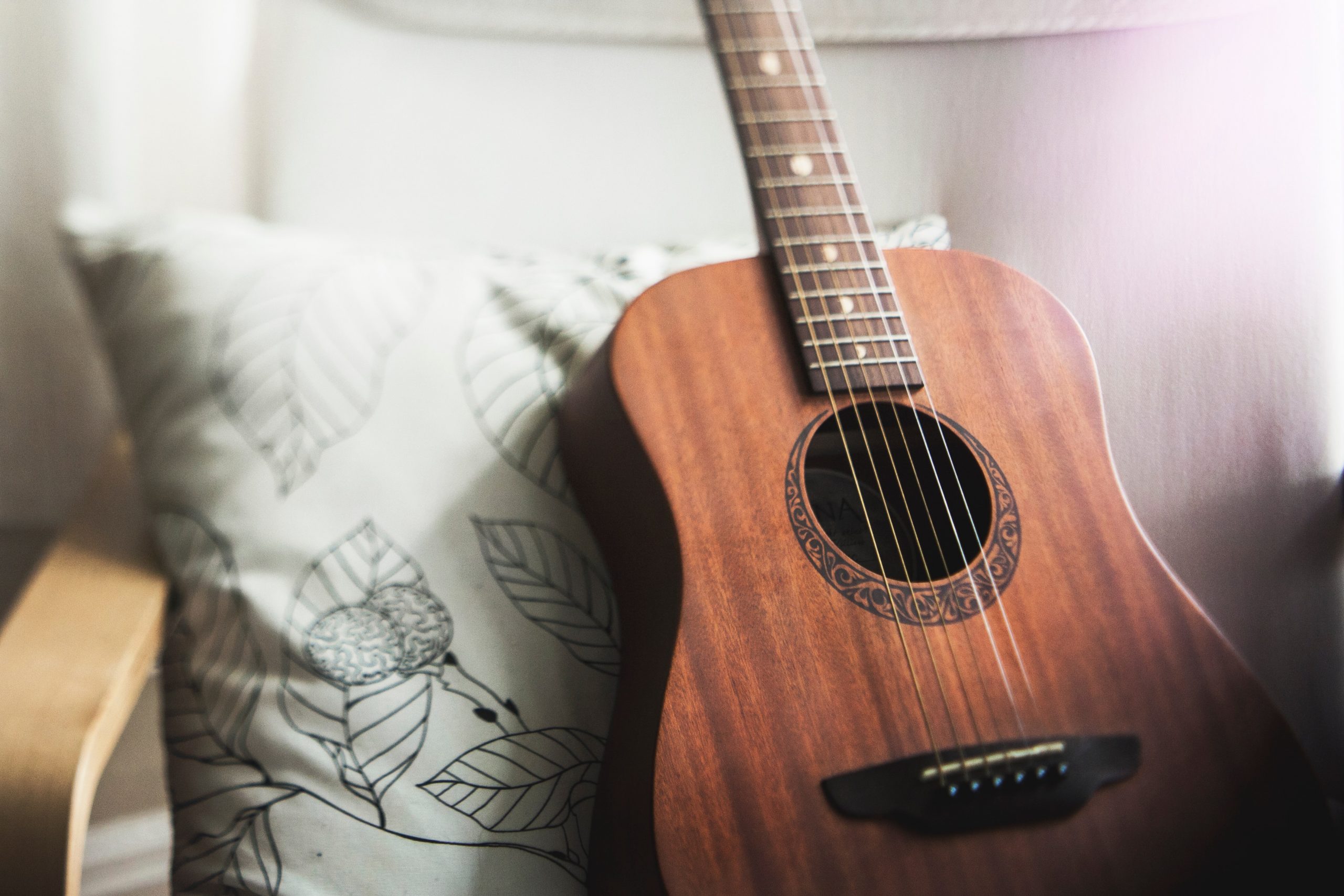 guitar resting against a pillow