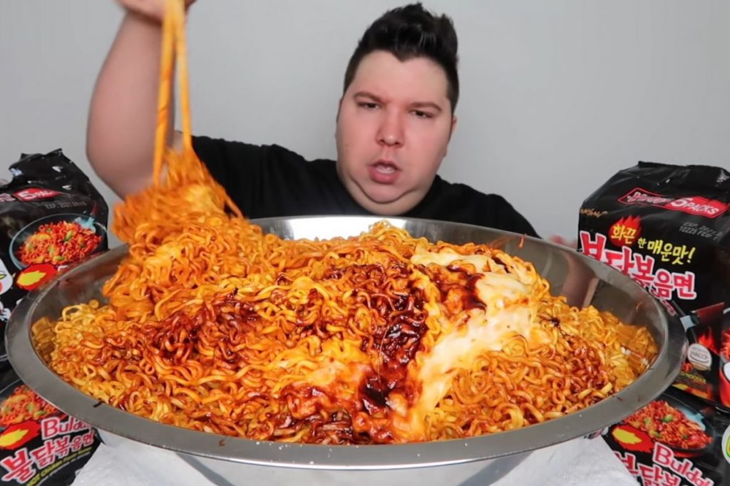 in article about mukbang culture, a screenshot of Nikocado Avocado eating ramen