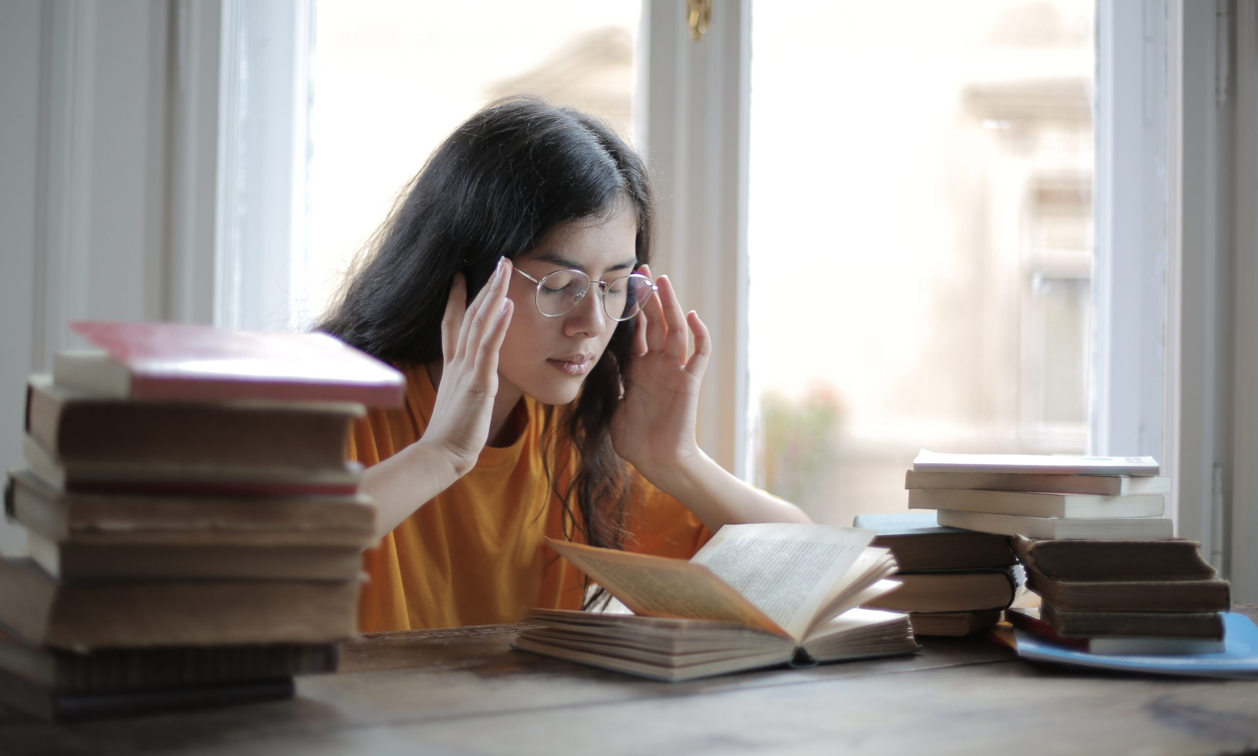 in article about money mistakes, a person holding their head in their hands
