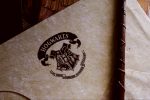 Photo of Hogwarts letter and wand in article about J K Rowling