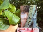 copies of the Uglies book series next to a potted plant