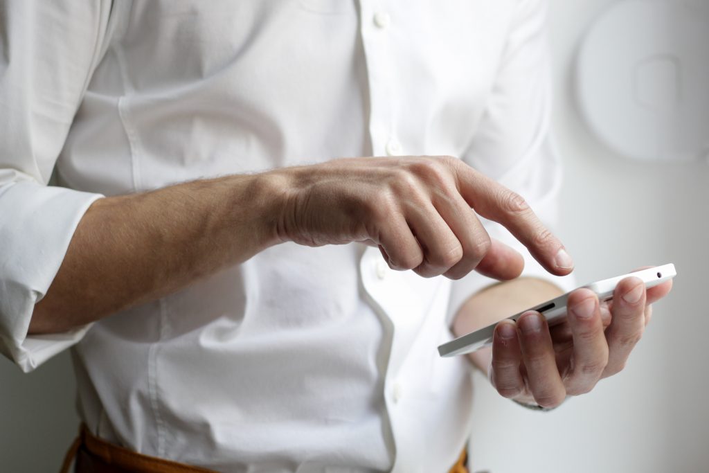 in article about mobile entertainment, person with mobile phone in their hand