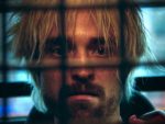 Pattinson in the back of a cop car in his film Crime Caper.