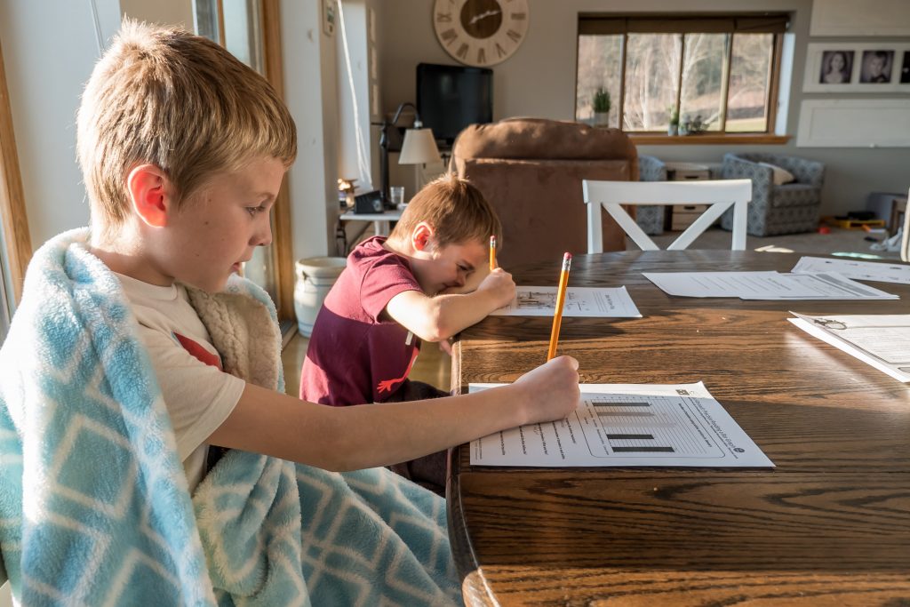 two homeschooled children at their desks