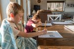 two homeschooled children at their desks