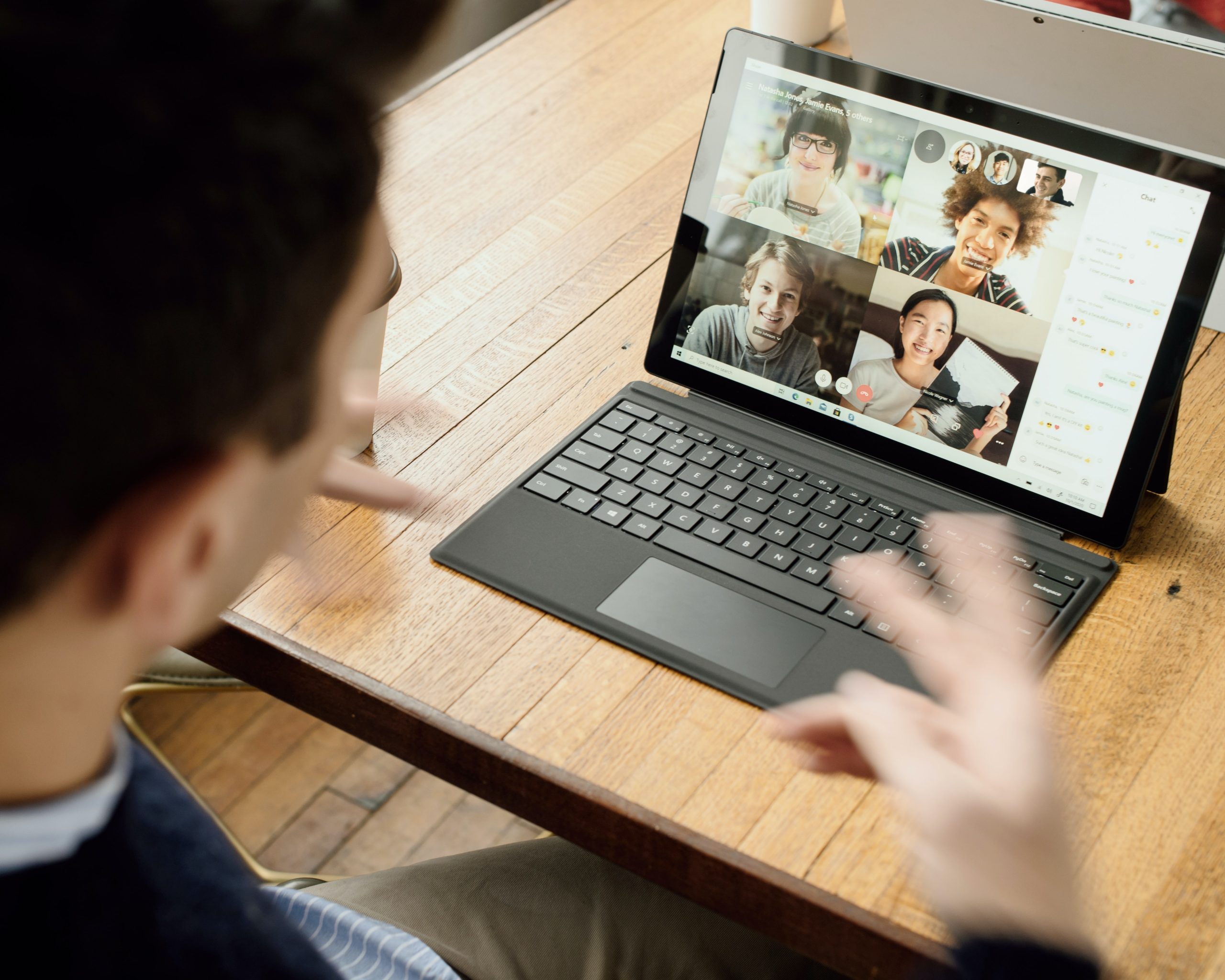 in article about making money from home, someone looking at a Zoom meeting on their laptop