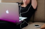 Female college student feeling the lack of motivation while on her computer during her senior year.