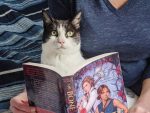 Leslie Vedder and cat reading the Bone Spindle